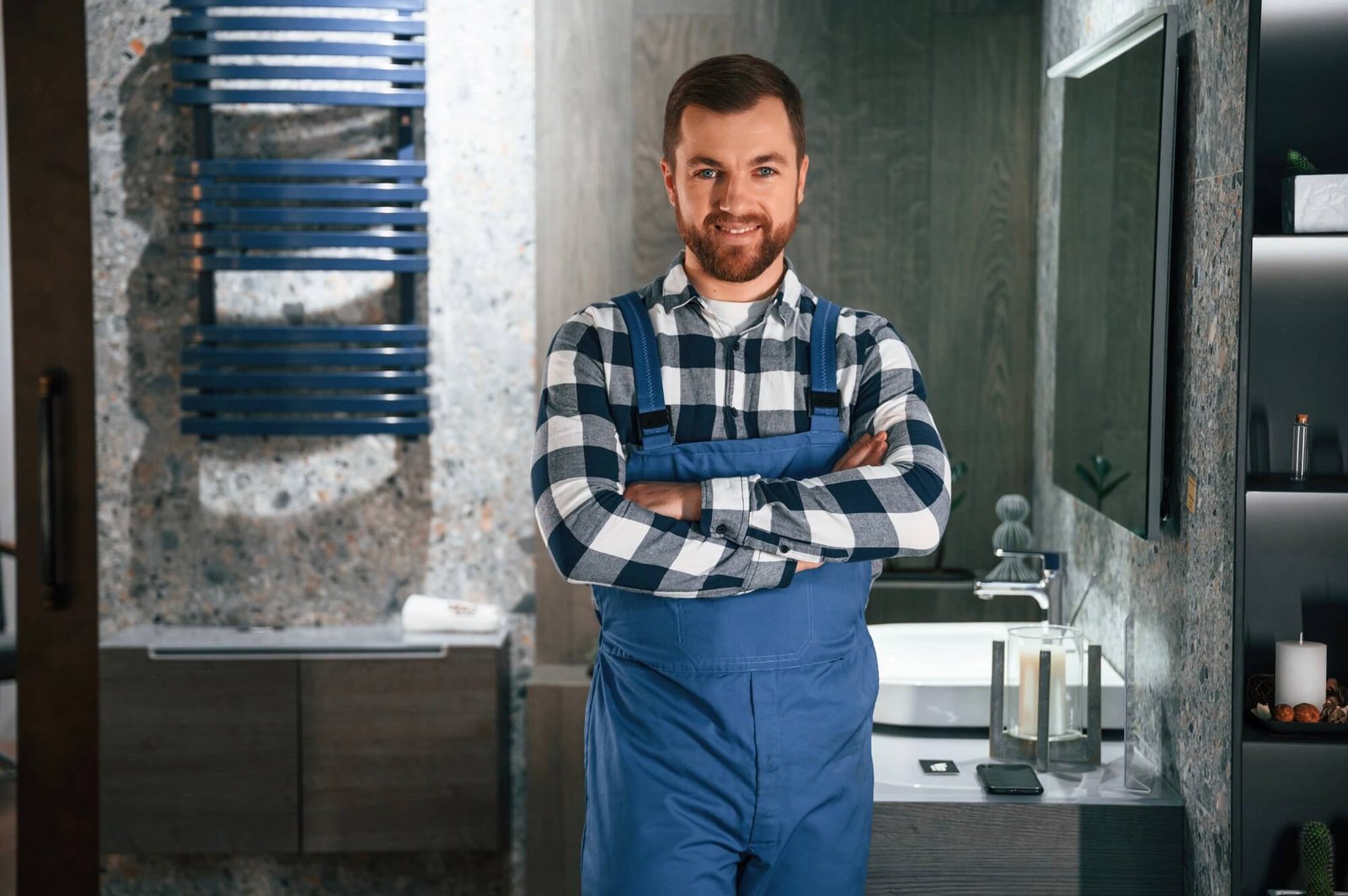 Confident drain cleaning technician standing in uniform in Dallas TX